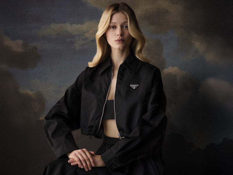 Photography and art direction of a blonde model wearing a Prada fashion jacket in front of a baroque painting, for Duel Magazine issue number 5.